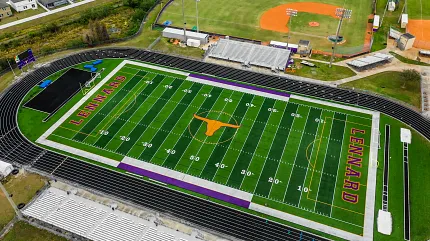 Sports field with track and seating from above Aerial view of a sports field with track and bleachers