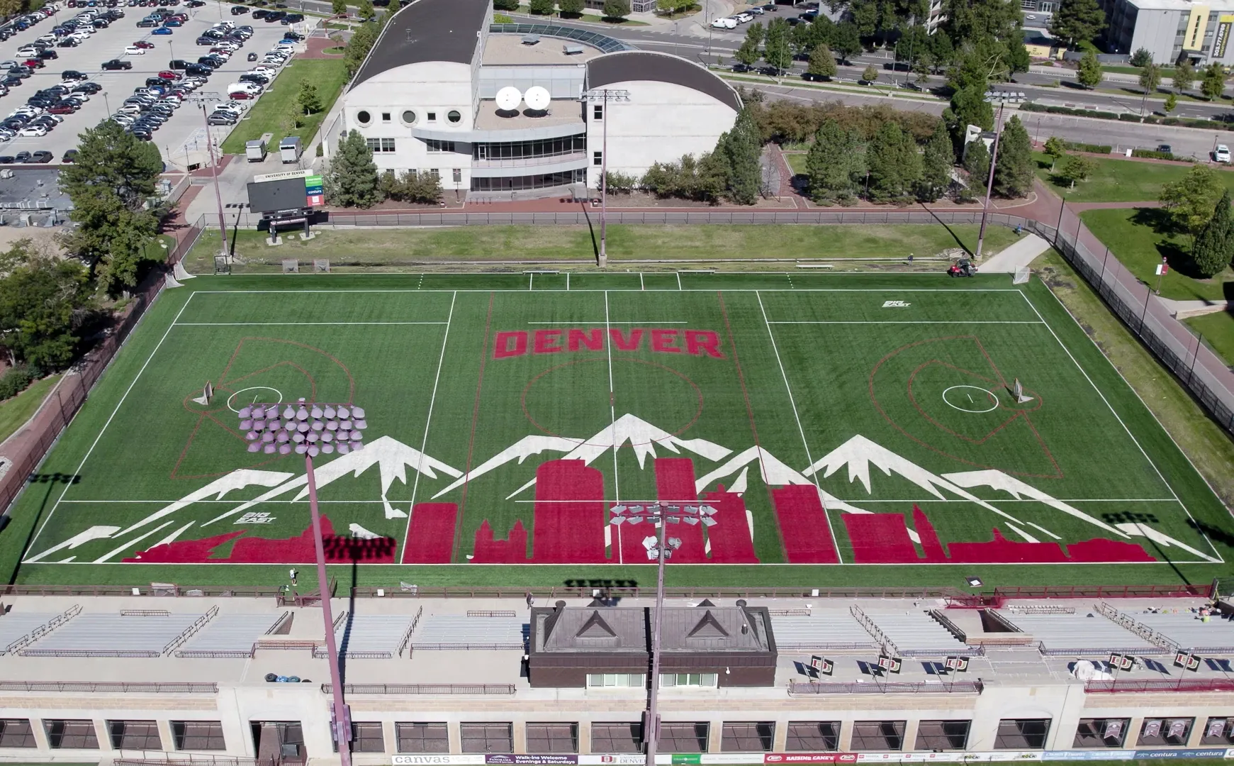 Aerial view of a sports field with Denver skyline and mountain design