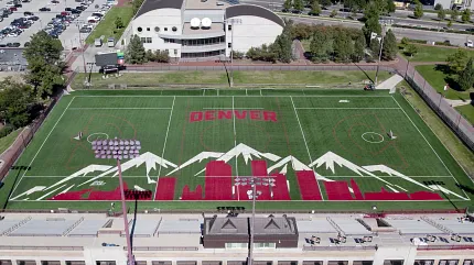 Scenic sports field with Denver and mountain artwork Aerial view of a sports field with Denver skyline and mountain design