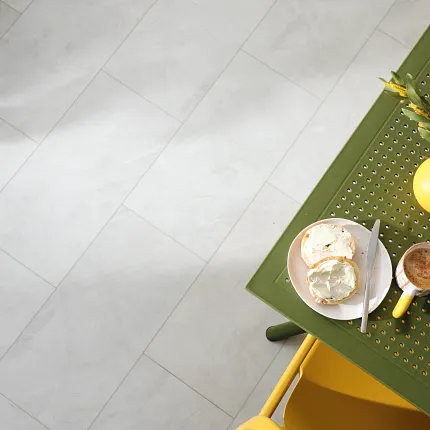 Light Stone Look Luxury Vinyl Tile Flooring - Coretec Residential SPC Light stone look luxury vinyl tile flooring with a green table and yellow chair, 24.02x12.01 inch, Coretec Residential SPC