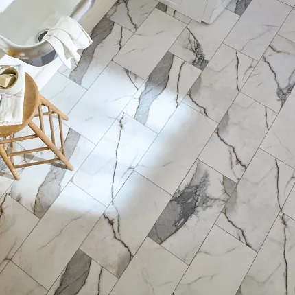 Durable and stylish marble-patterned tile flooring for a comfortable home ambiance Elegant marble-patterned tile flooring in a bright bathroom setting with a wooden stool and bathtub