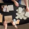 <h2 class="text-bodycopy-l"><span style="color:#ffffff;"><strong>Need Design Help?</strong></span></h2>
 Overhead view of two people selecting flooring samples including carpet, hardwood, and tile on a black table