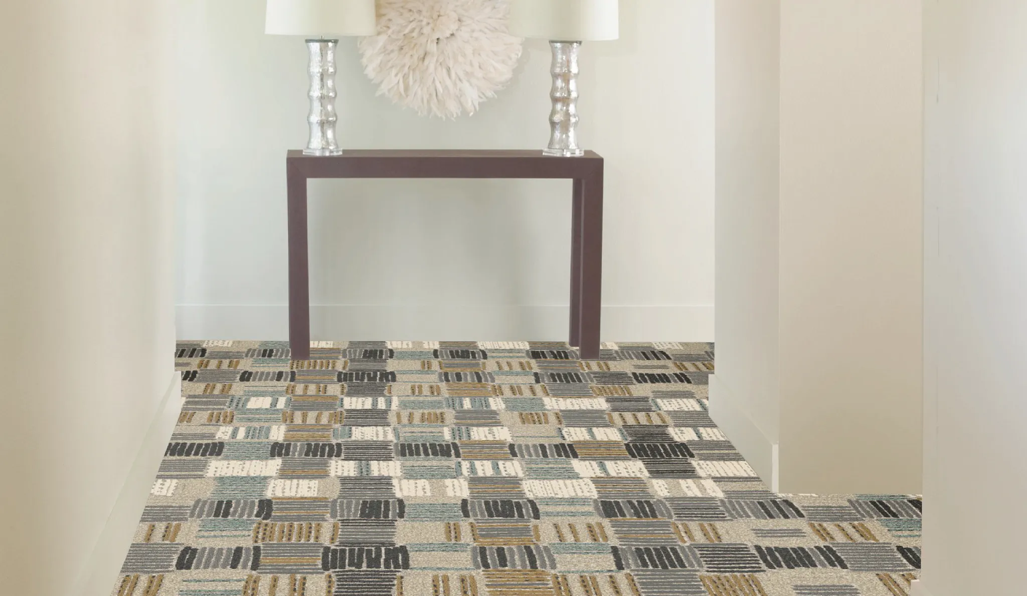 Modern hallway with patterned commercial carpet tile in shades of beige, gray, and brown