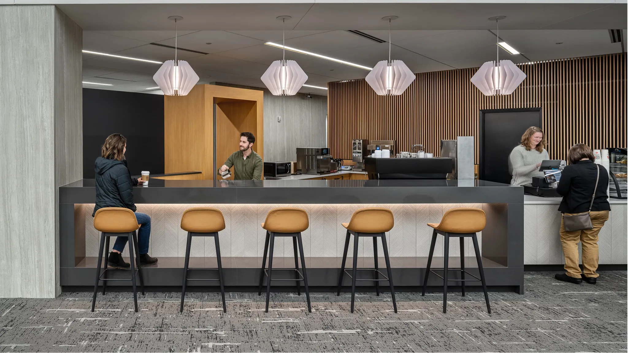 View of the interior lobby in the atrium, people ordering coffee and sitting down looking pleasant
