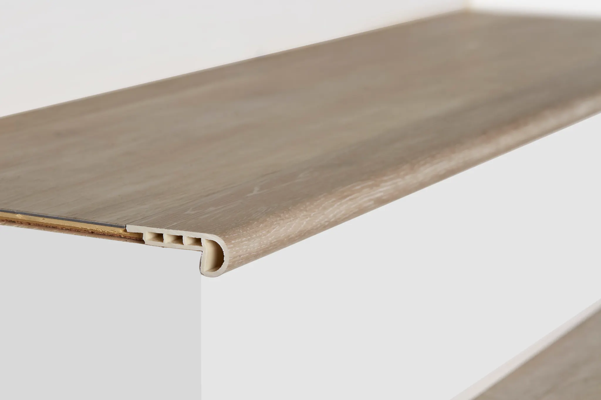 Light wood finish stair nose with grooved edge