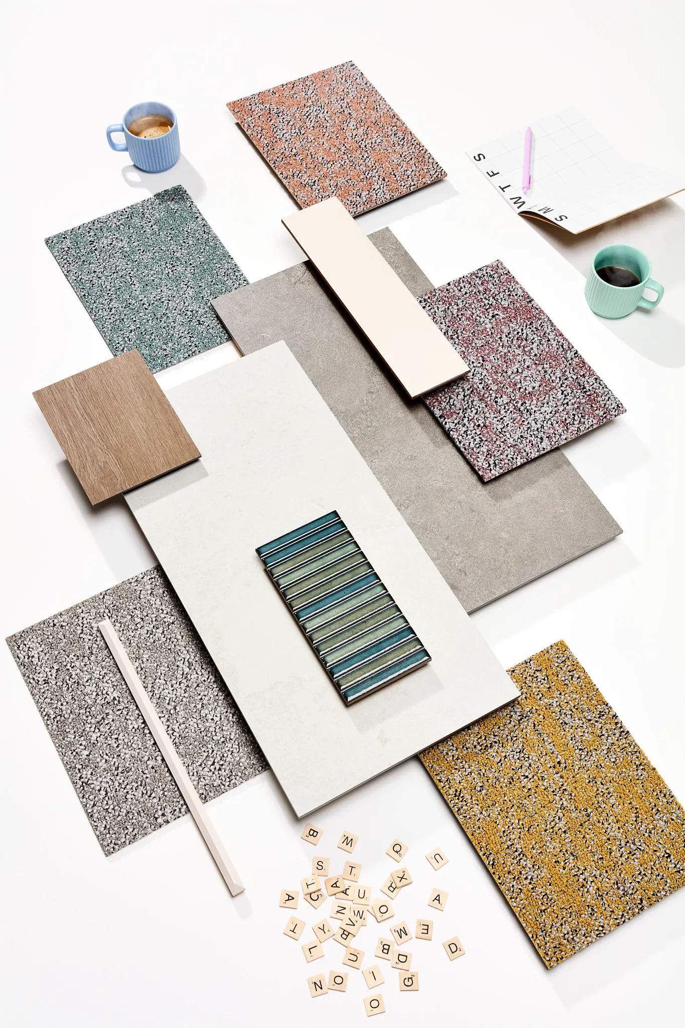 Assorted flooring samples including blue, green, red, grey, and yellow textures